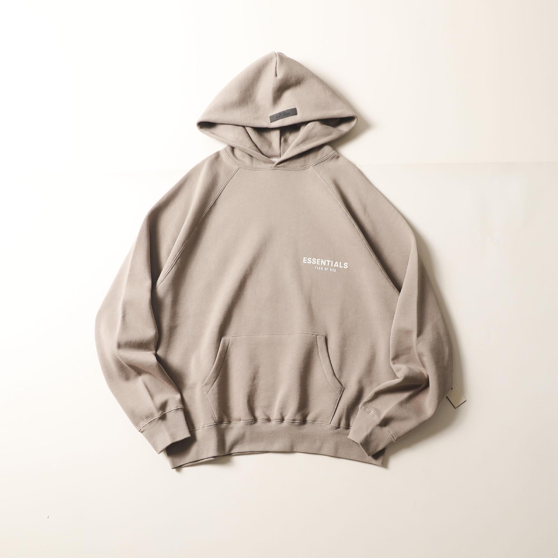 Cozy and stylish gray hoodie with minimalist "Essential" text branding on the chest, perfect for casual street wear.