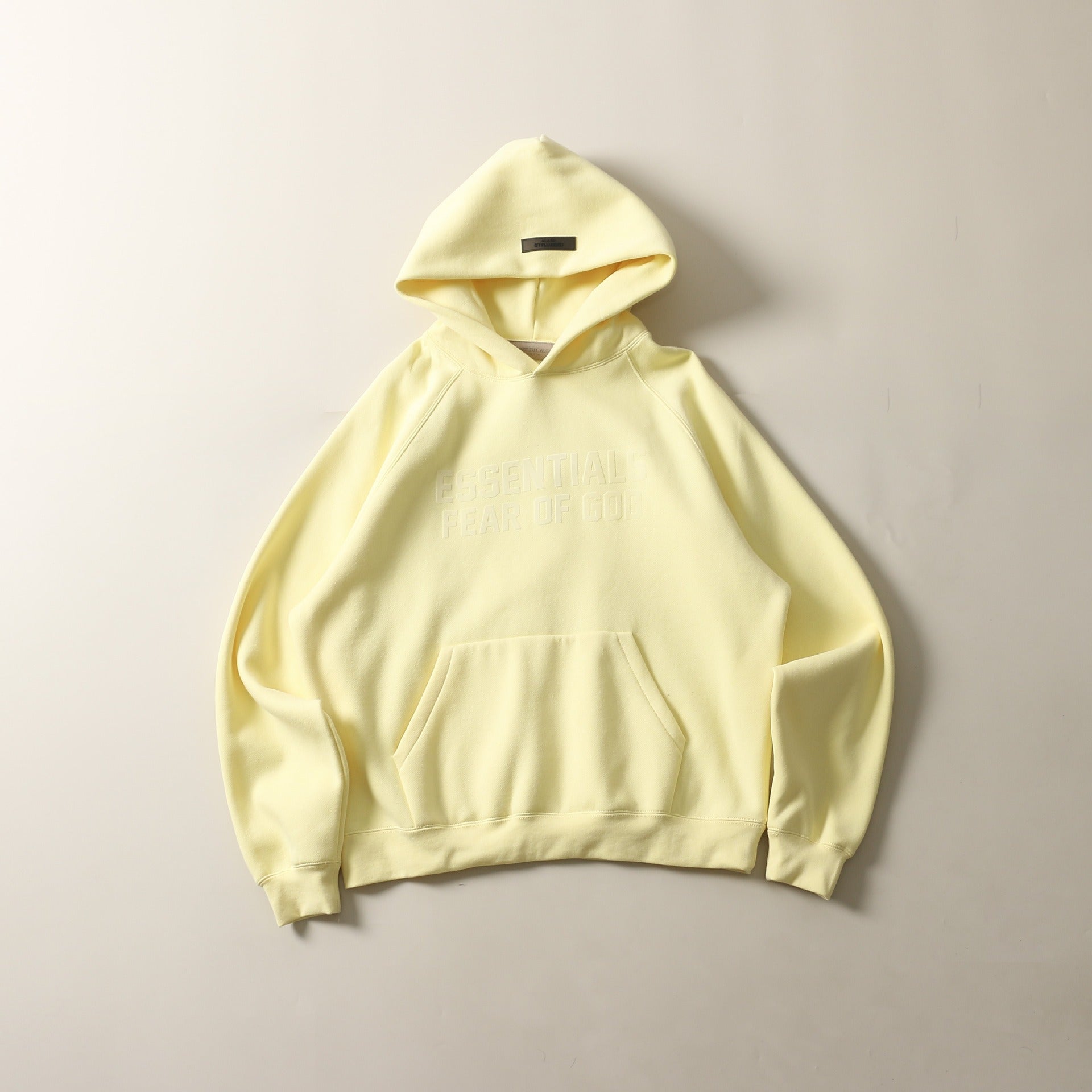 Cozy yellow hoodie with double line design and flocked printed pattern for a trendy streetwear look.