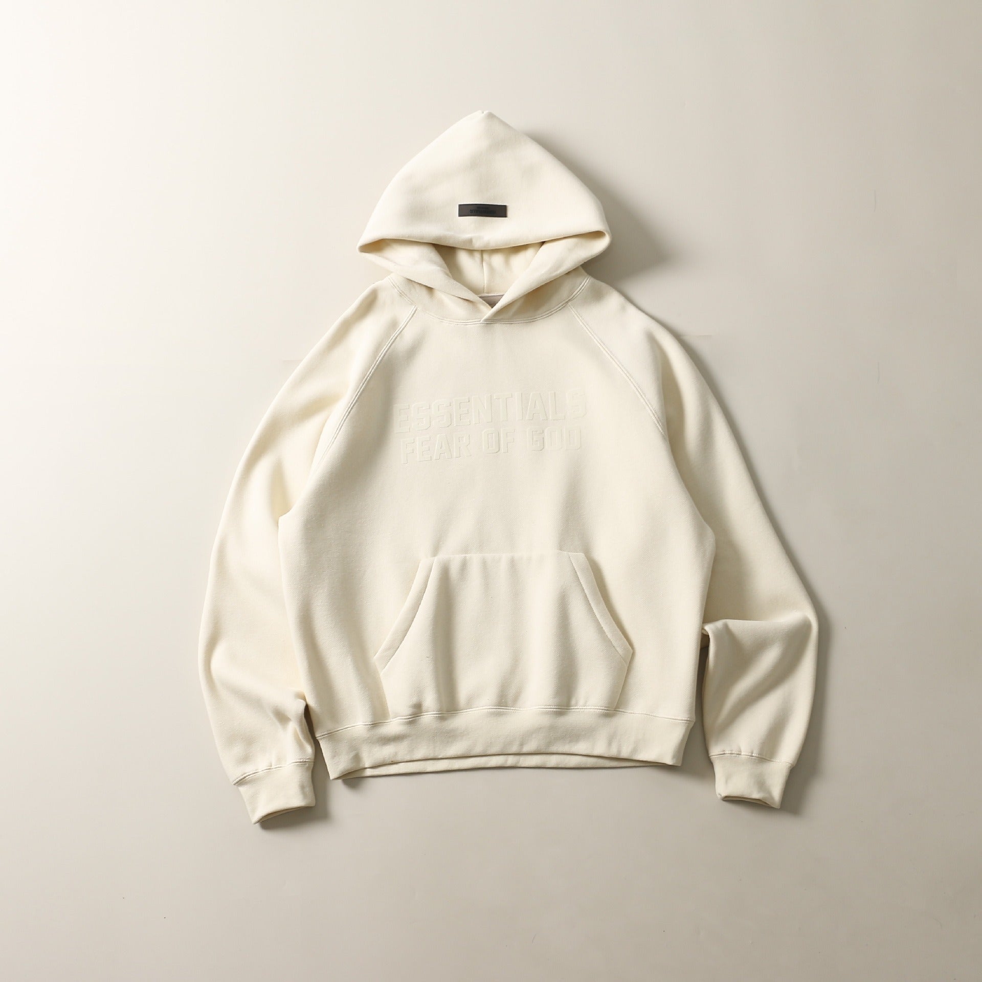 Soft, cozy white pullover hoodie with a front kangaroo pocket and drawstring hood, showcased against a plain background.