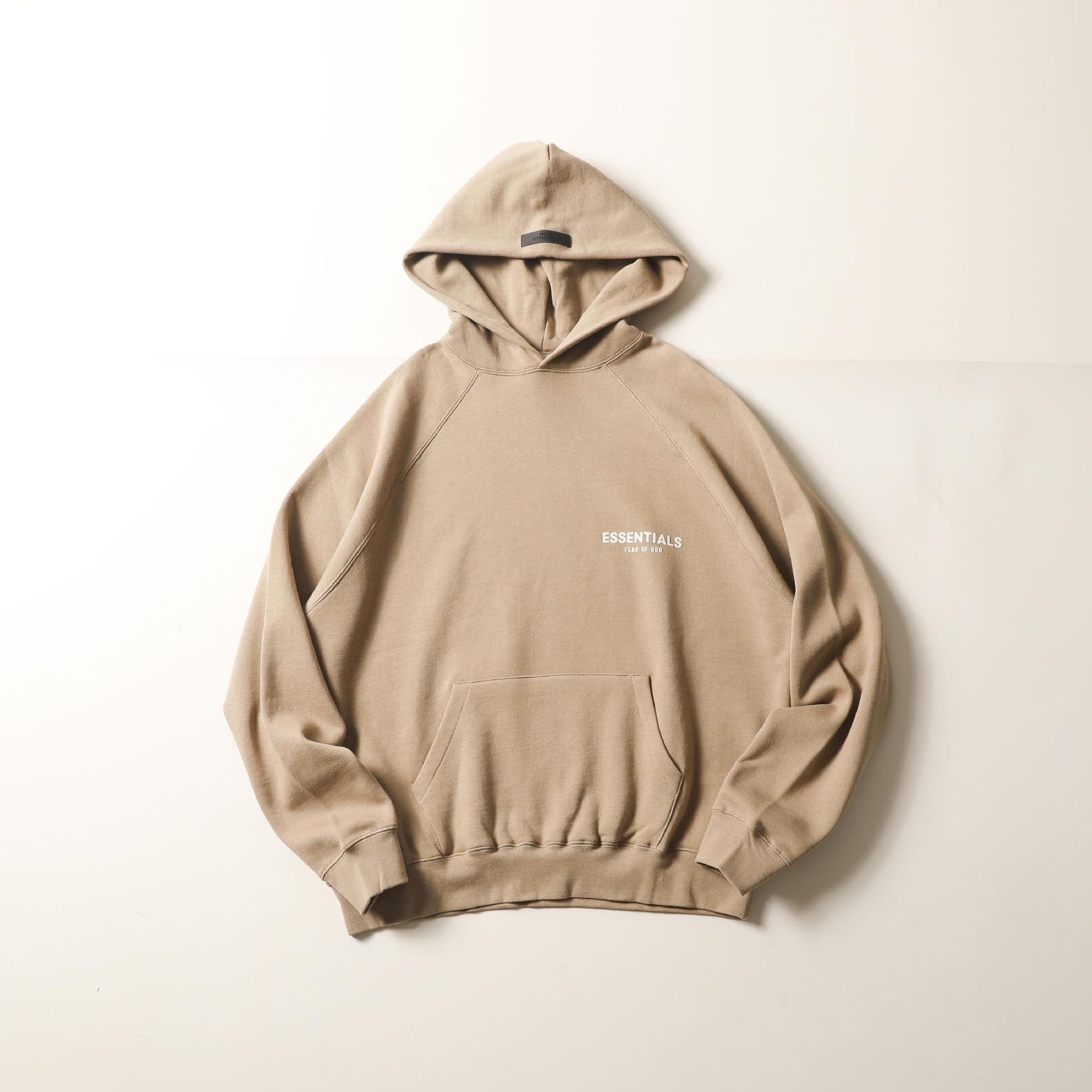 Beige hooded sweatshirt with small logo print on the chest, displayed against a plain white background.